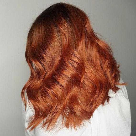 Side profile of woman with copper ombre hair, created using Wella Professionals.