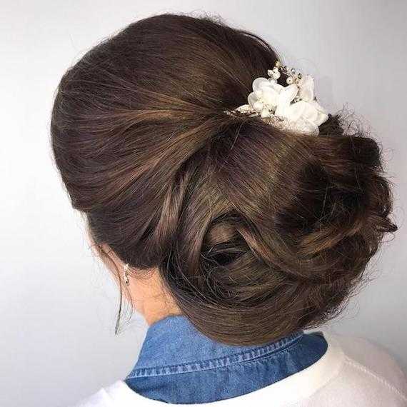 Photo of the back of a woman’s head with hair styled in a wedding chignon, created using Wella Professionals